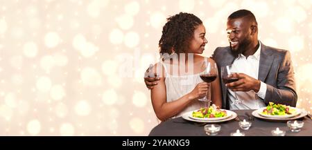 Young black couple having festive dinner at restaurant Stock Photo