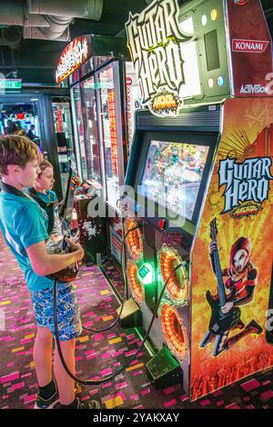 Trieste Italy,Norwegian Cruise Line NCL Escape ship,10-day Mediterranean Adriatic Sea itinerary,onboard inside interior,passengers boys playing Guitar Stock Photo