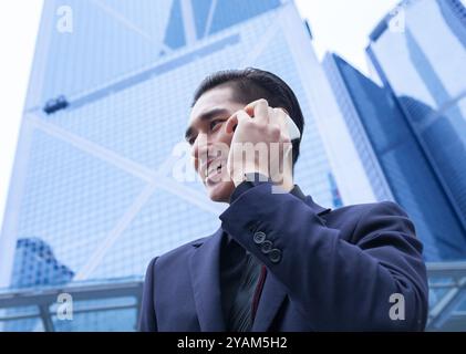 Businessman talking on phone in the city. Stock Photo