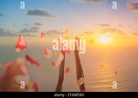 Rose petals falling from woman hands Stock Photo
