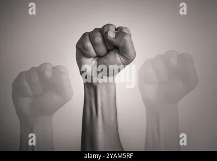 Strong mans fist up in the air, strength determination concept Stock Photo
