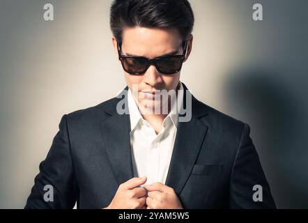 Young fashion man wearing a suit. Fashion business shoot. Stock Photo