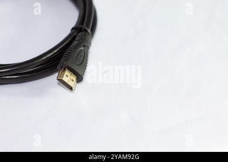 HDMI CABLE WITH WHITE BACKGROUND ISOLATED IN CLOSE UP PHOTO FROM TOP ANGLE Stock Photo