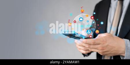 Social media and digital online communication concept, man using smartphone with likes icons on social media. Comments, likes and new followers, commu Stock Photo
