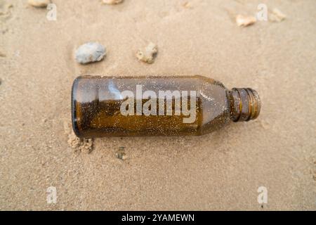 Empty glass bottles washed up on the beach Stock Photo