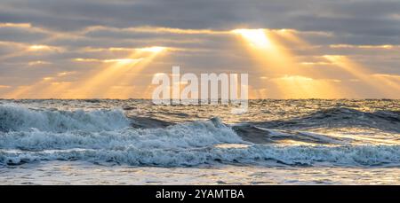 Sun rays illuminate the Atlantic coastline shortly after sunrise in Jacksonville Beach, Florida. (USA) Stock Photo