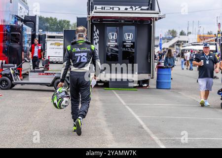 Sep 03, 2023-Portland, OR: INDYCAR Series driver, AGUSTIN HUGO CANAPINO (R) (78) of Arrecifes, Argentina, walks back to the pits after crashing out du Stock Photo