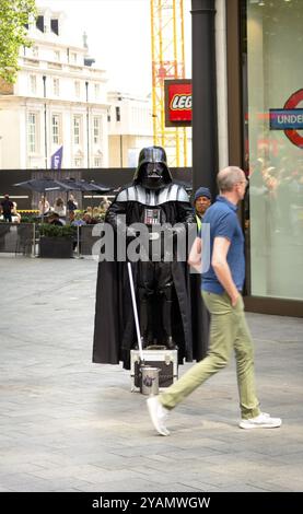 London has a great variety of street performers. Even Darth Vader knows the advantage to be seen in London City Stock Photo