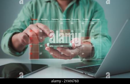 Businessman marking dates on virtual calendar, Time management concept, Planning work to increase efficiency, Business project planning, Effective tim Stock Photo