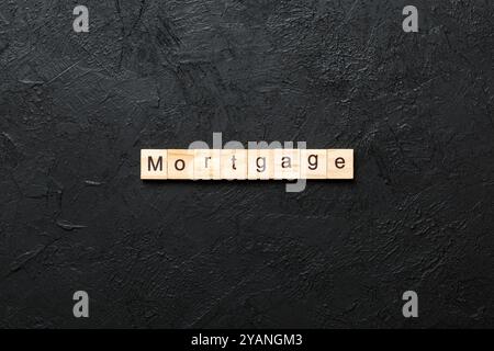 MORTGAGE word written on wood block. MORTGAGE text on cement table for your desing, concept. Stock Photo