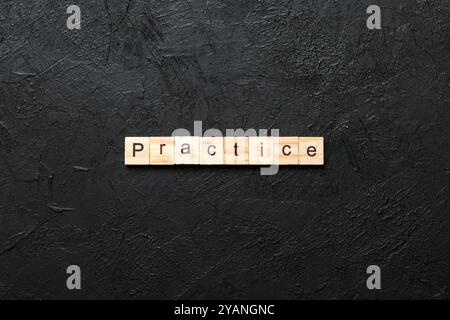 practice word written on wood block. practice text on table, concept. Stock Photo