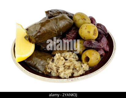 Stuffed vine leaves filled with rice and herbs and mixed Mediterranean olives on a small plate isolated on a white background Stock Photo