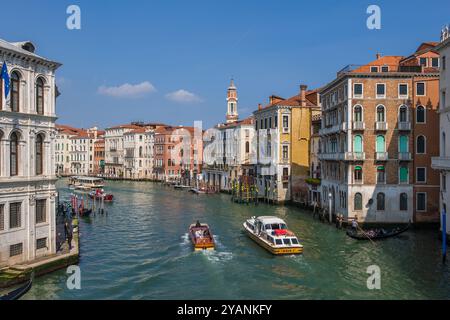 Venice, Italy - March 20, 2024 - City skyline with the Grand Canal, Alilaguna water bus and water taxi, view from the Rialto Bridge. Stock Photo