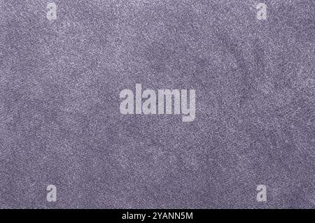 pastel lilac fabric texture with a subtle pattern, providing a smooth, soft surface. Stock Photo