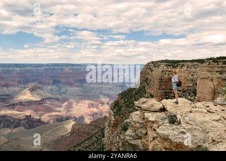 Hiker with arms up standing on the top of the mountain - Successful man enjoying triumph - Sport and success concept Stock Photo