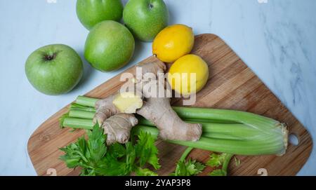 Green apple ginger lemon and celery stalks. detox concept and healthy food. Stock Photo