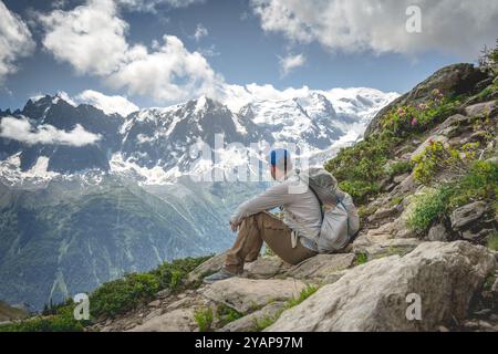 Hiker on the Tour du Mont Blanc, looking towards Aiguille du midi from le Brevent Stock Photo