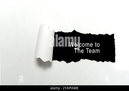 Torn piece of paper showing word "Welcome to the team" written on it. Concept of unity and collaboration. Design for business or marketing concept Stock Photo