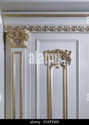 Detail of a wainscoting wall with golden ornaments Stock Photo