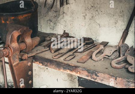 Old rusty tools on an old workbench in a museum Stock Photo