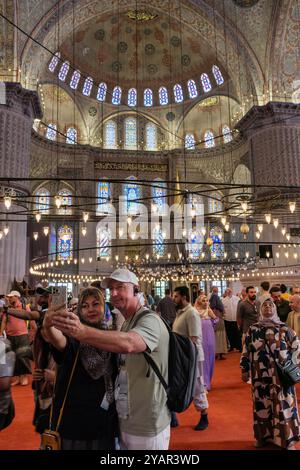 A couple taking a selfie in the Blue Mosque, Istanbul, Turkey Stock Photo