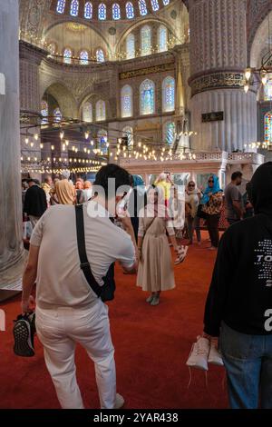 An Asian couple taking photographs in the Blue Mosque, Istanbul, Turkey Stock Photo