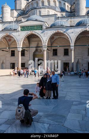 A family pose for a snapshot at Blue Mosque, Istanbul, Turkey Stock Photo