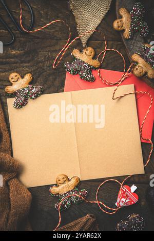 Scene for gifts in Advent with cookies, gift ribbon and card for text on dark wooden back ground, christmas concept. copy space, top view, vertical Stock Photo