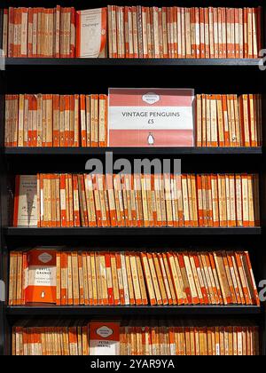 Vintage used orange spine Penguin paperback books for sale in Waterstones bookshop, Leeds Stock Photo