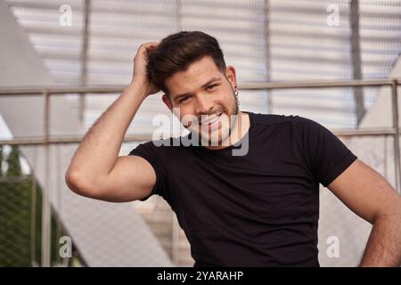 portrait of a young dark-haired latin man looking at the camera smiling Stock Photo