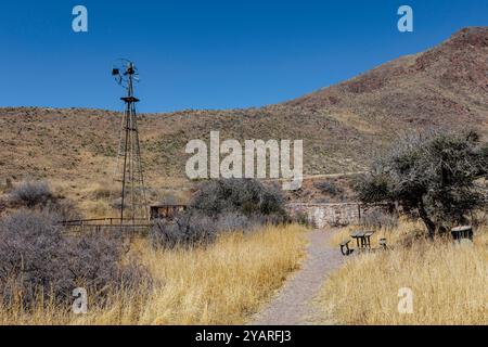 Picnic table and old abandoned windmill along the Bar Canyon Trail in Organ Mountains - Desert Peaks National Monument in New Mexico, USA Stock Photo