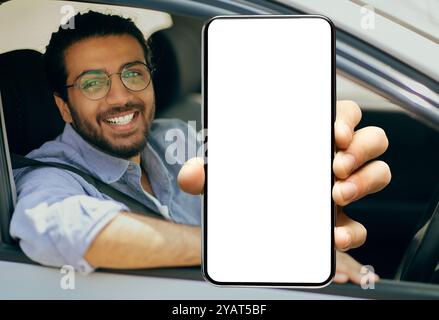 Happy indian driver using showing smartphone with empty screen Stock Photo