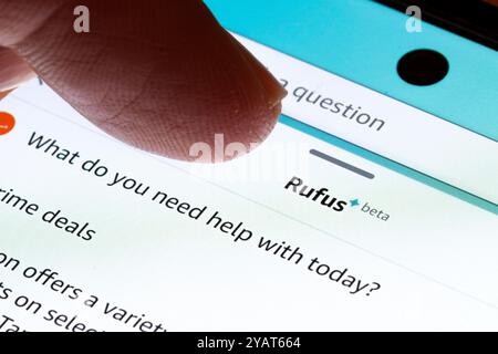 Finger interacting with the Amazon Rufus AI assistant interface on a mobile device. Stafford, United Kingdom, October 15, 2024. Stock Photo