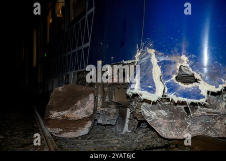 Namborn, Germany. 15th Oct, 2024. The power car of a vlexx regional express train is standing next to the rails in the track bed. The boulder that caused the accident is lying next to it. The regional train had collided with the large boulder on the tracks and derailed on the open track. Credit: Laszlo Pinter/dpa/Alamy Live News Stock Photo