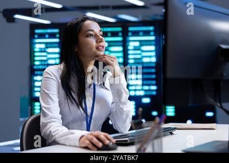 Admin in data center using computer to check for server performance issues arising due to high CPU usage. Server room employee at PC fixing insufficient memory errors slowing down hardware Stock Photo