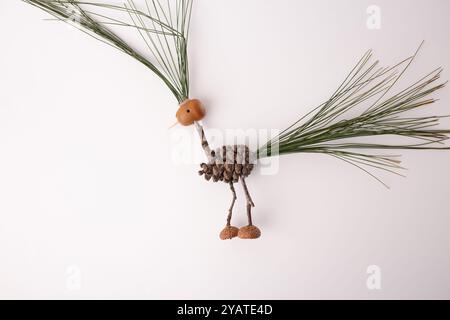 step in creative process, DIY, autumn craft, handmade bird crafted from pine cones and twigs, creativity and resourcefulness in using natural elements Stock Photo