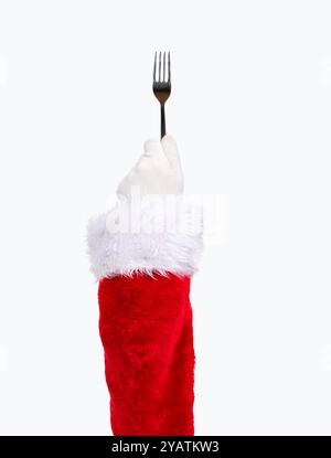 Santa Claus hand using a dessert fork isolated on a white background Stock Photo