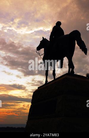 A statue of Union General Meade faces the sunset at Gettysburg National Military Park Stock Photo