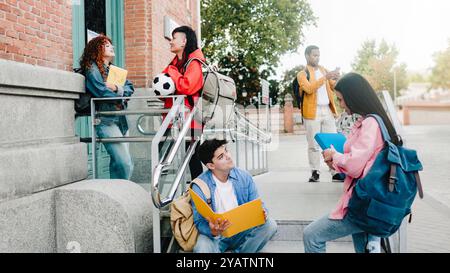 Diverse students having fun outside school university campus. Group of people talk outdoors. Education concept Stock Photo