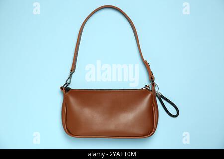 Bag with black leather keychain on light blue background, top view Stock Photo