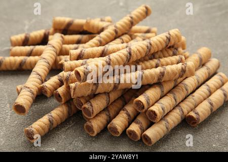 Coffee wafer stick roll with coffee cream on grey background. Space for text Stock Photo