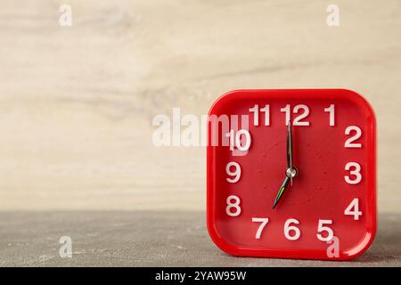 Good morning concept - modern alarm clock and houseplant on light background. Top view Stock Photo