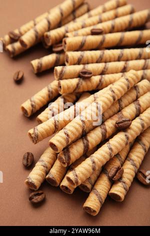 Coffee wafer stick roll with coffee cream on brown background. Top view Stock Photo
