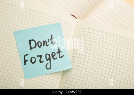 Open notepad and sticky notes with word don't forget. Top view Stock Photo