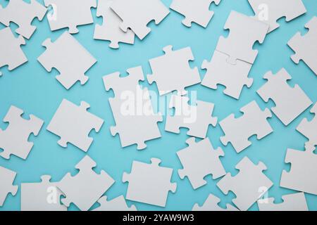 Close-up of a pile of uncompleted elements of a white puzzle. A huge number of rectangular pieces from one large white mosaic. Top view Stock Photo