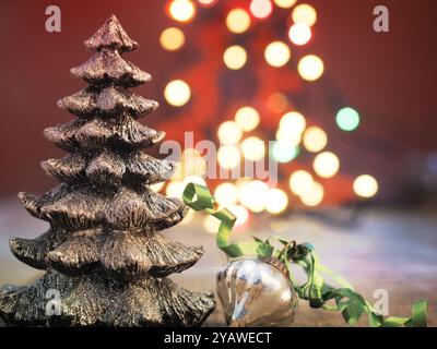 Christmas tree shape with Christmas bauble on a blurred Christmas lights background Stock Photo