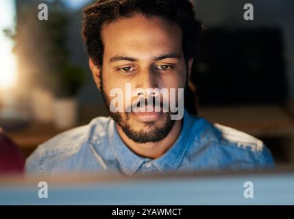 African man, laptop and night for communication, deadline or project management in office with app. Web designer, tech and research for target Stock Photo