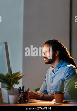 African man, computer and night for research, communication or project management in office with app. Web designer, tech and seo for target audience Stock Photo