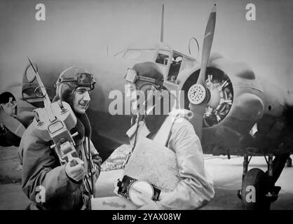 Flight crews with an Avro Anson (named after British Admiral George Anson) a British twin-engined, multi-role aircraft that served with the Royal Air Force (RAF) and Fleet Air Arm (FAA) during the Second World War. It was developed during the mid-1930s in response to a request for tenders issued by the British Air Ministry for a maritime reconnaissance aircraft. Initially used for maritime reconnaissance operation alongside the larger flying boats it was soon found to have become obsolete in front line combat roles and put to use as a multi-engined aircrew trainer. Stock Photo