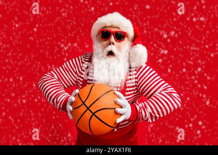 Portrait of his he nice handsome amazed worried nervous fat overweight Santa grandfather playing basketball practicing throwing ball isolated over Stock Photo